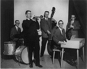 Portrait of Dr. John Zdechlik playing the piano as a member of an ensemble.