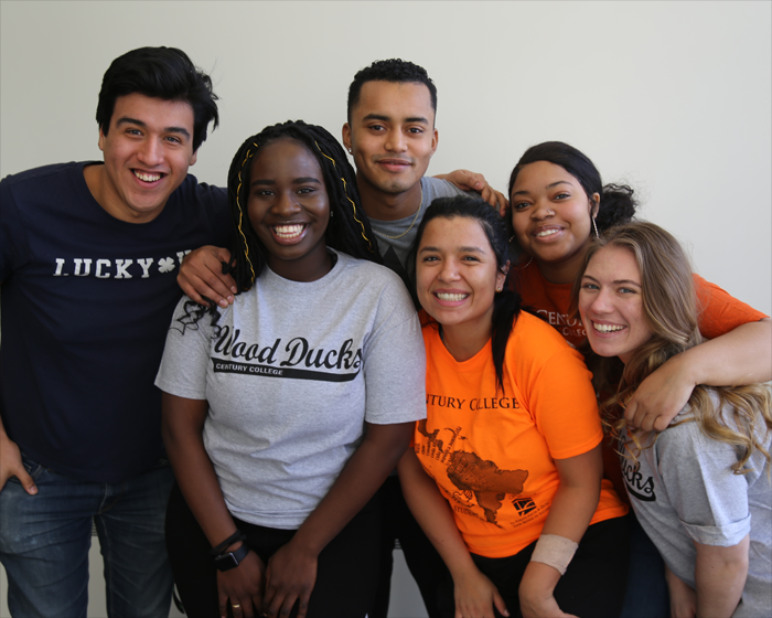 A diverse group of students wearing various Century College branded apparel.