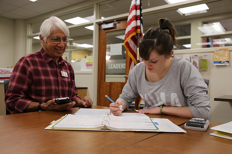 Two people working together in the Veterans Center.