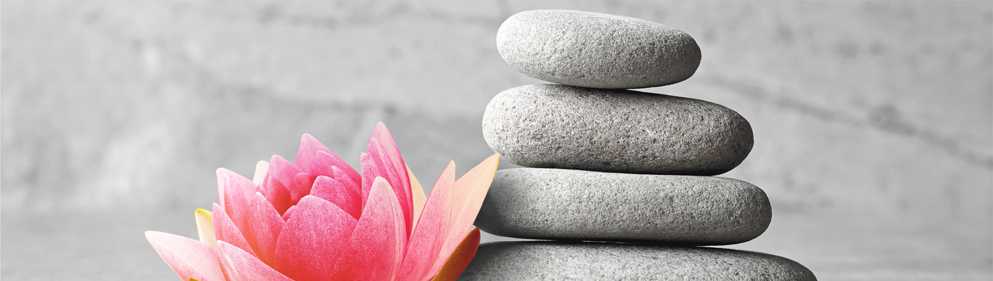 Beautiful pink lotus flower and stones balance, concept of wellness spa treatments for the beauty of mind and body, massage, zen stone.