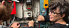 Two students working on the electrical panel in the boiler room.