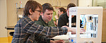 Students 3-D printing into petri dishes in the Bio Fab Lab.