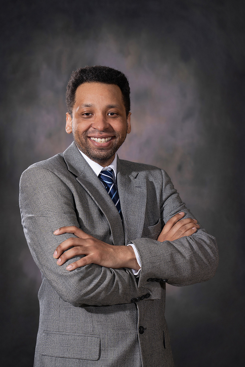 Student photography work. The image captures a portrait of another student in a suit for professional headshots.