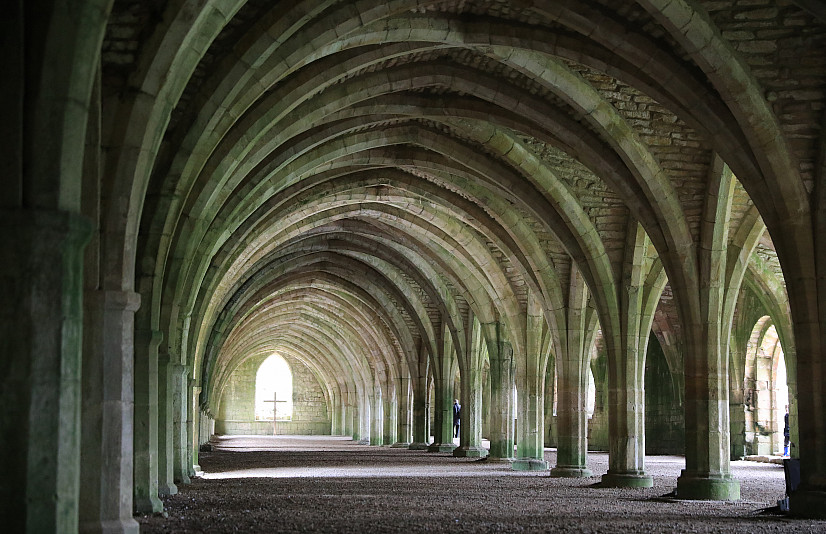 Student photography work. The image captures the architecture of a hallway with repeating columns and archways.